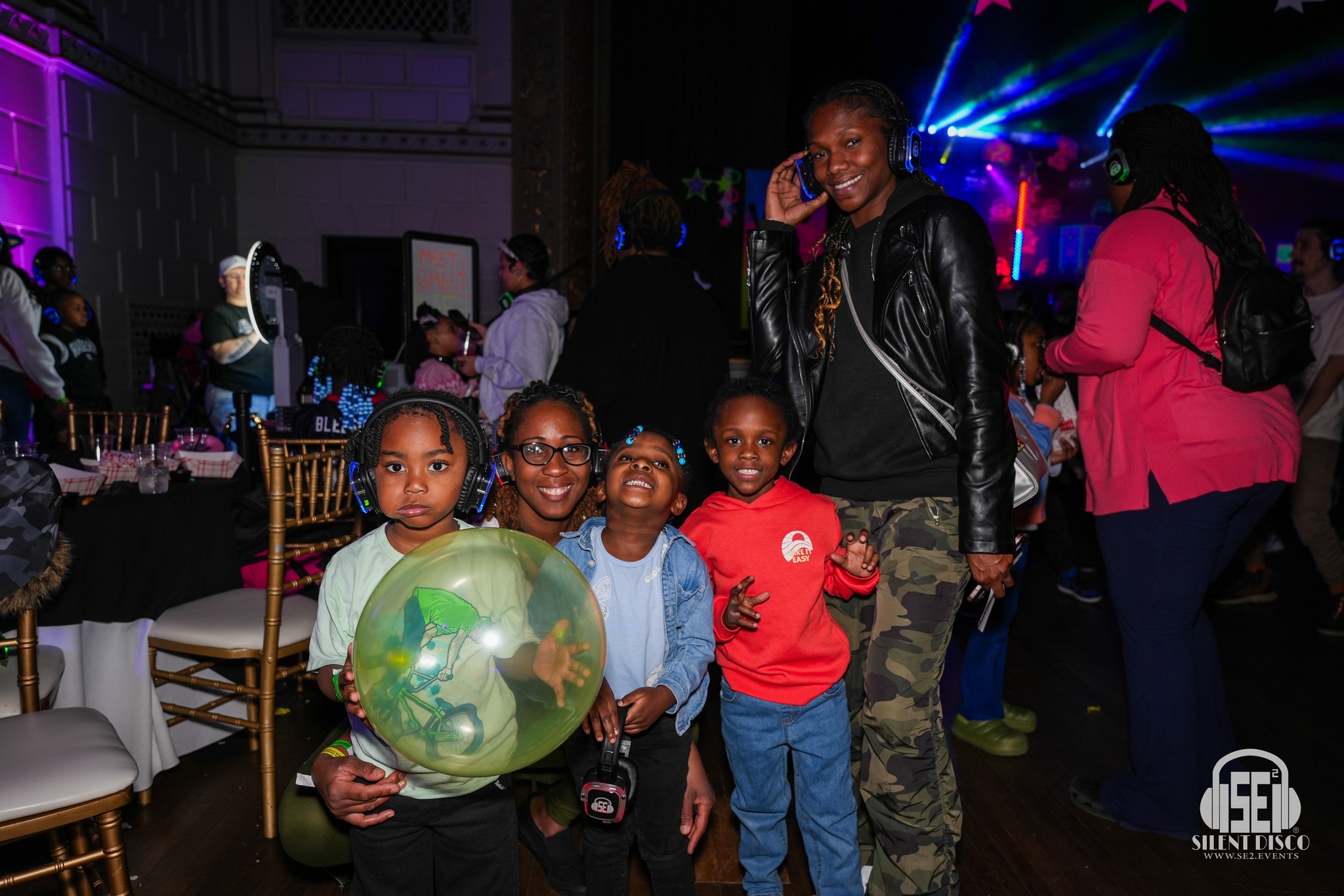 Kids and parents dancing in SE2 silent disco headphones at a Family Fun silent disco at 500 Pearl in Buffalo