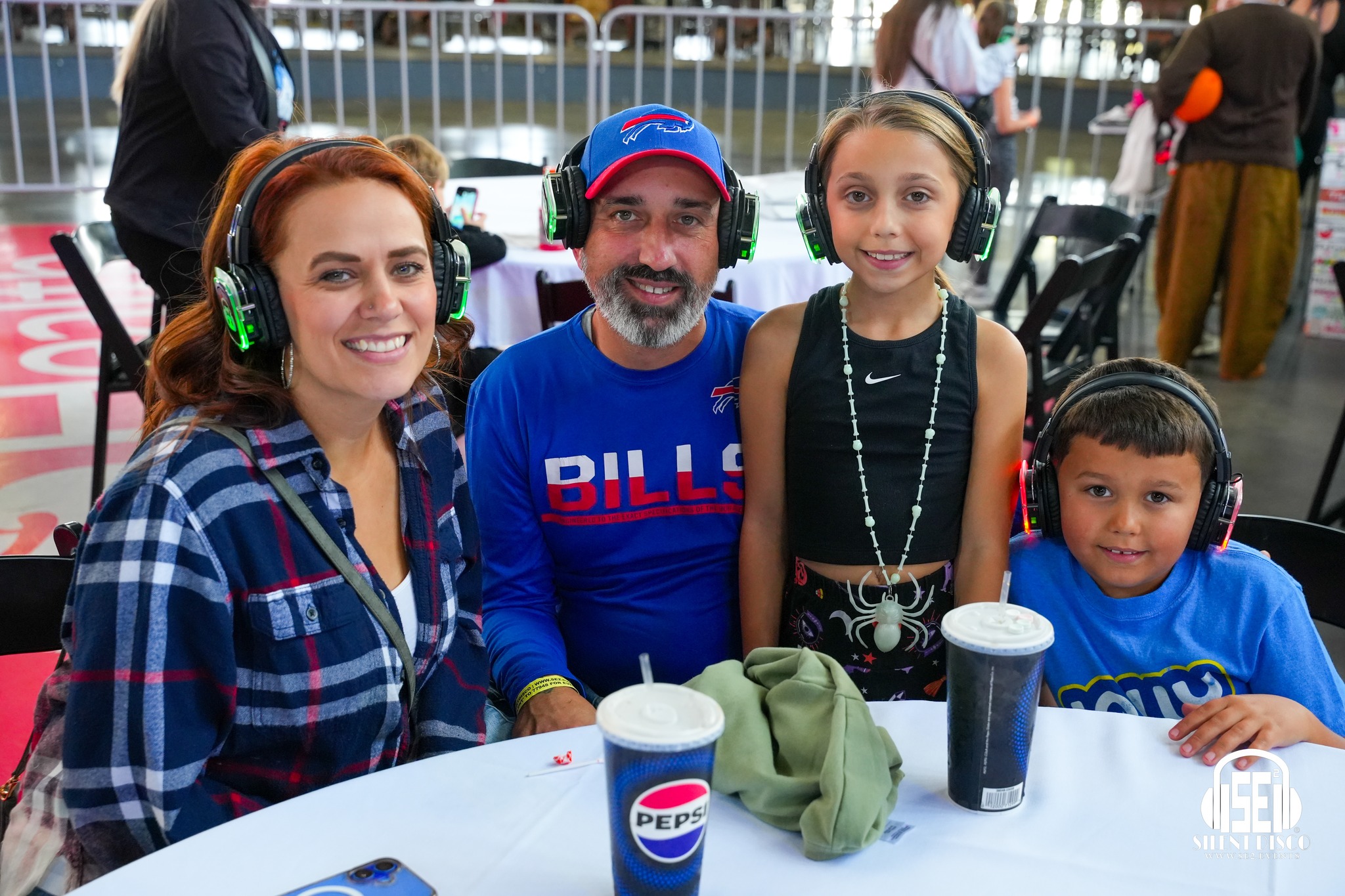 Families dancing with SE2 silent disco headphones at a family-friendly event at Buffalo RiverWorks